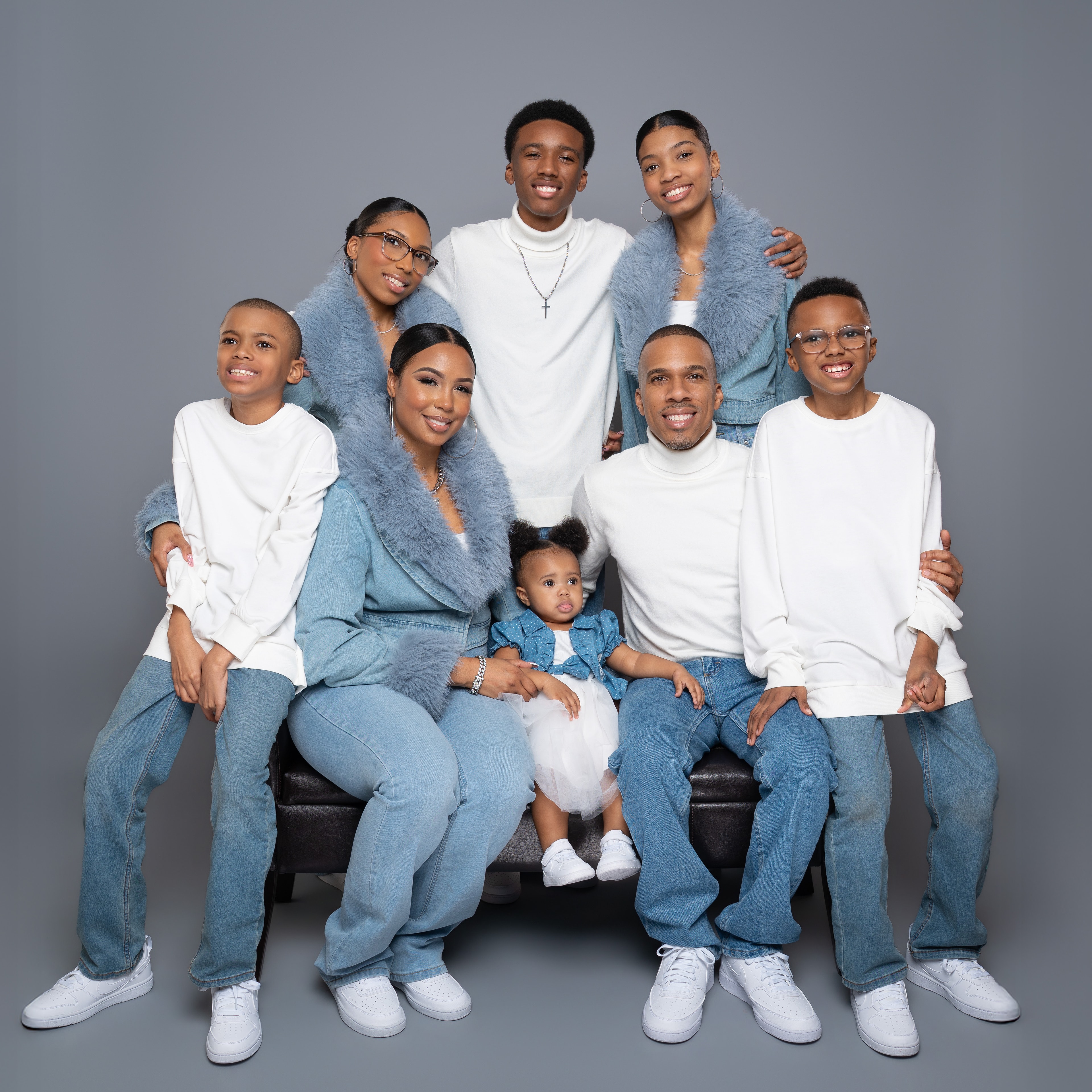 Quentin Mezetin with his family — his wife and six children in a professional portrait